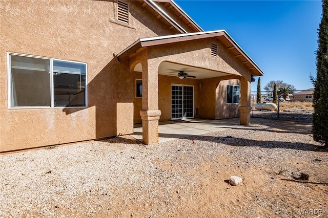 back of property featuring a patio area, stucco siding, and ceiling fan