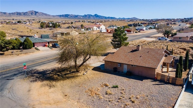 aerial view with a mountain view, a residential view, and view of desert