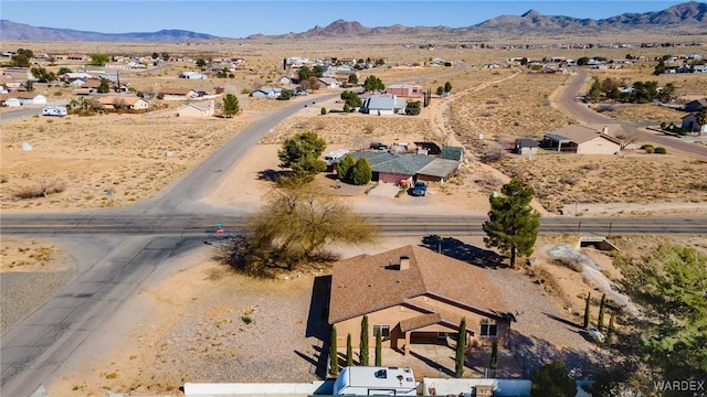 drone / aerial view featuring a mountain view and view of desert