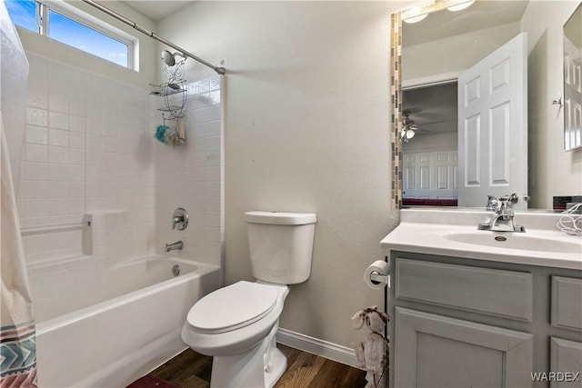 full bath featuring toilet, shower / bath combo with shower curtain, vanity, wood finished floors, and baseboards