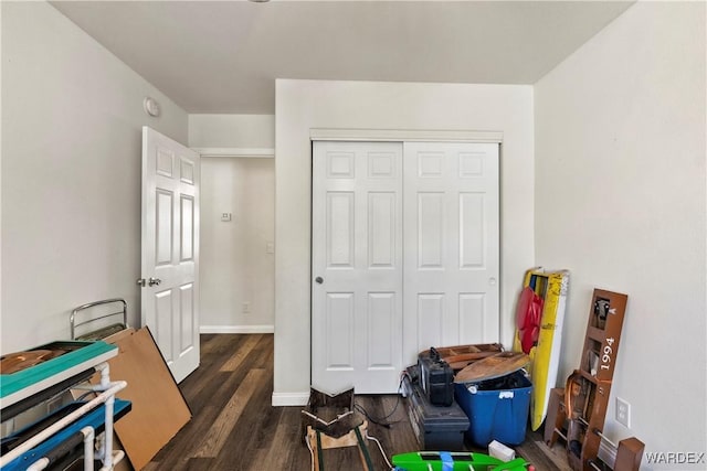 rec room with baseboards and dark wood-style flooring