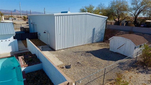 view of shed with fence