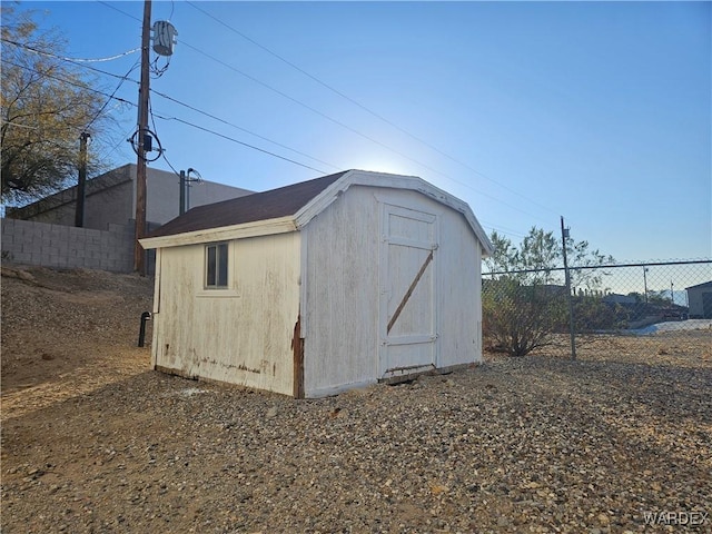 view of shed with fence