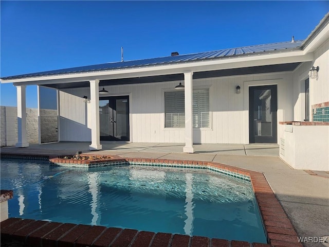 outdoor pool with a ceiling fan and a patio area