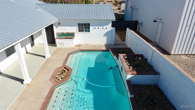 outdoor pool with a patio area