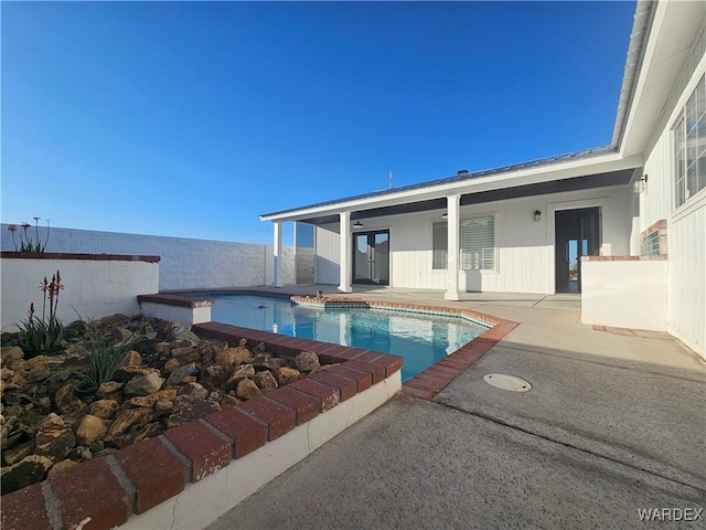 view of pool featuring fence, a fenced in pool, and a patio