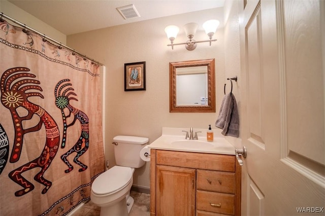 full bathroom featuring toilet, vanity, visible vents, and tile patterned floors