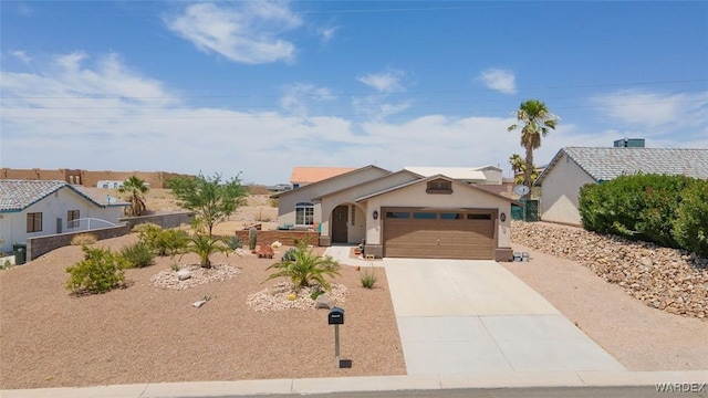 single story home with a garage, concrete driveway, fence, and stucco siding