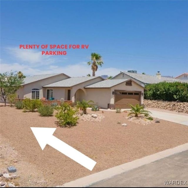 ranch-style house with a garage, concrete driveway, and stucco siding