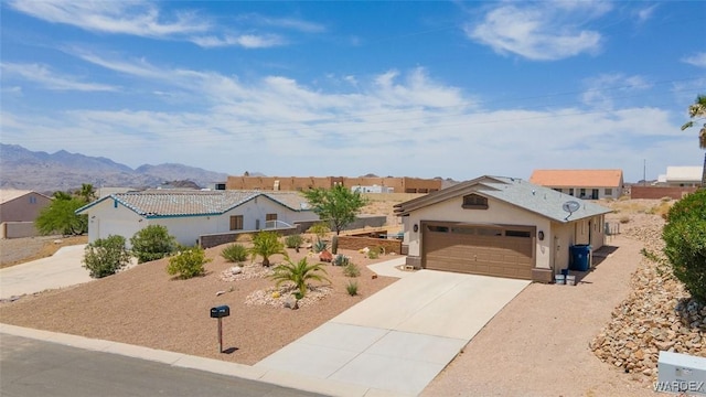 view of front facade featuring driveway, a garage, a mountain view, and a residential view