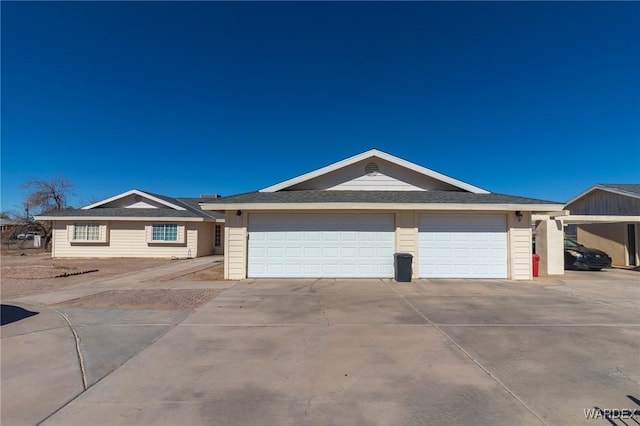 ranch-style home with concrete driveway