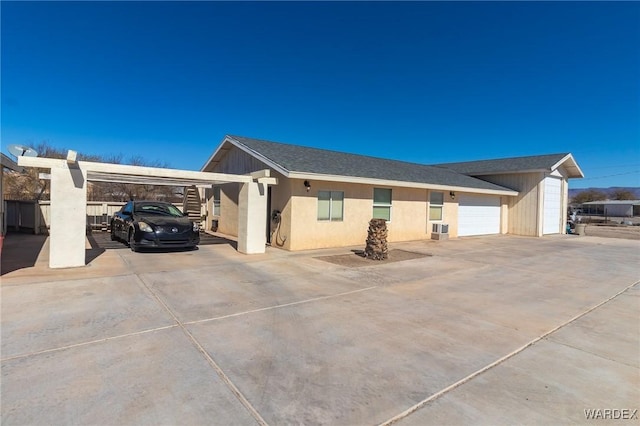 view of side of home with a garage and a shingled roof