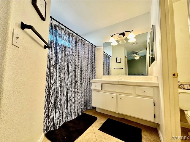 full bath with toilet, a ceiling fan, vanity, and tile patterned floors