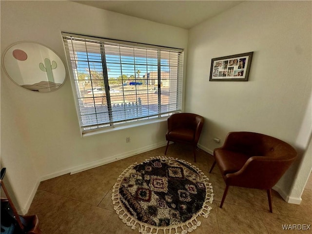 sitting room with tile patterned flooring and baseboards