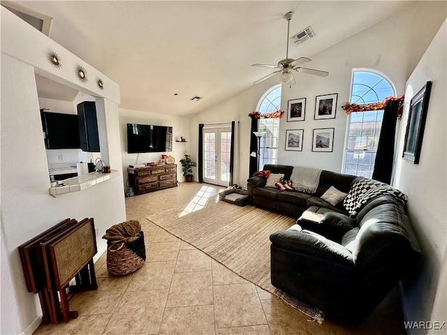 living area with french doors, visible vents, plenty of natural light, and light tile patterned floors