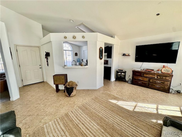 living room with baseboards and vaulted ceiling