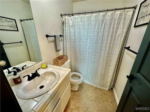 full bath featuring vanity, toilet, and tile patterned floors