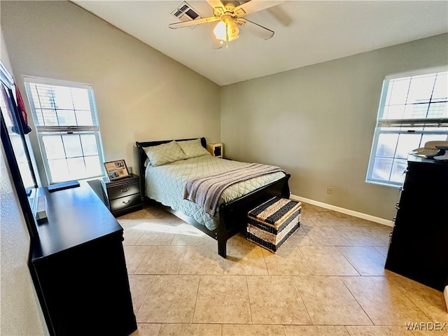 bedroom featuring light tile patterned floors, visible vents, ceiling fan, vaulted ceiling, and baseboards