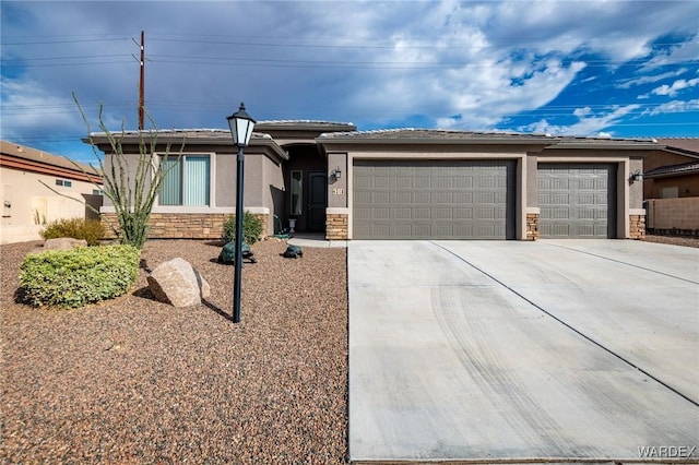 view of front facade with a garage, stone siding, driveway, and stucco siding