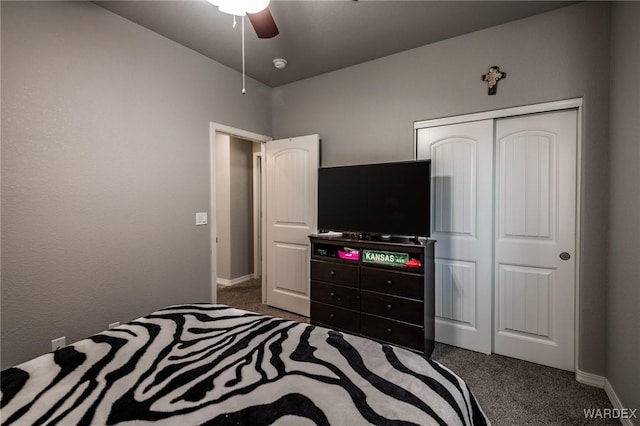 bedroom with dark colored carpet, a closet, ceiling fan, and baseboards