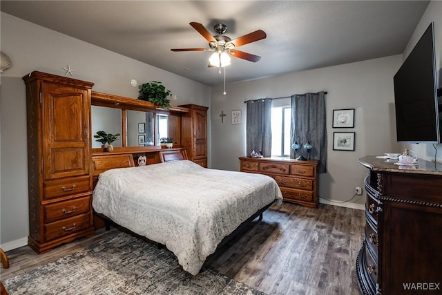 bedroom with dark wood-style floors, baseboards, and a ceiling fan