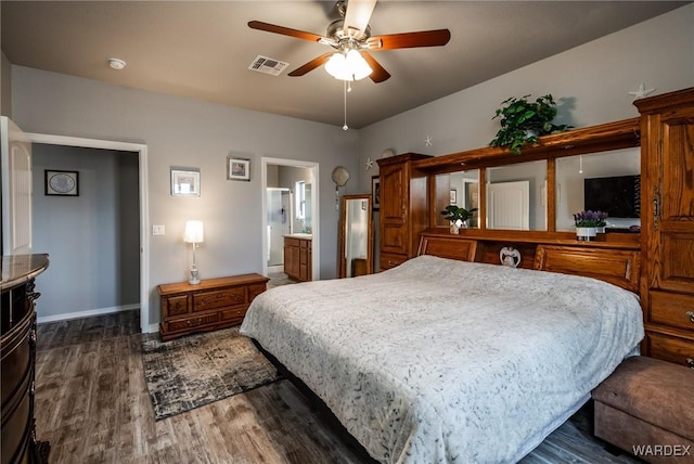 bedroom with dark wood-style floors, visible vents, and baseboards