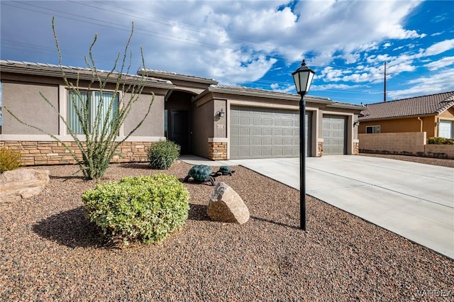 single story home with stone siding, driveway, an attached garage, and stucco siding