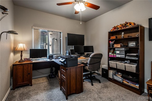 carpeted home office featuring a ceiling fan and baseboards