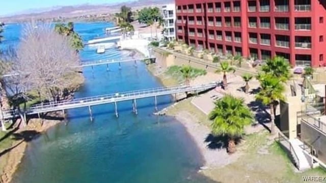 birds eye view of property featuring a water and mountain view