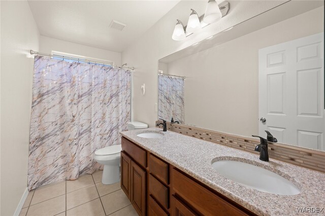 full bathroom with toilet, visible vents, a sink, and tile patterned floors