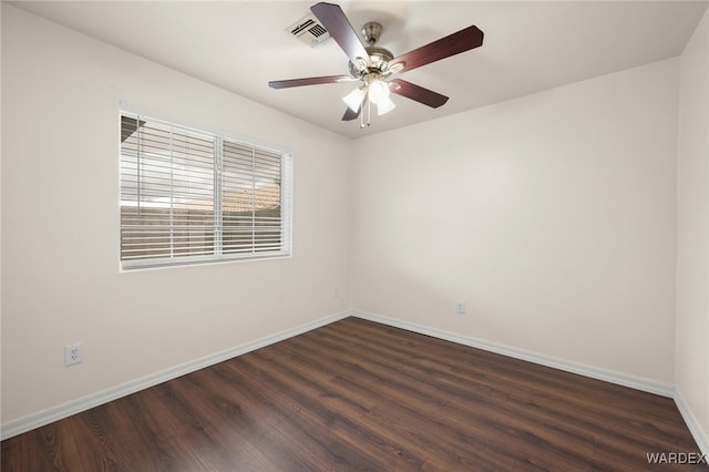 spare room featuring ceiling fan, wood finished floors, visible vents, and baseboards