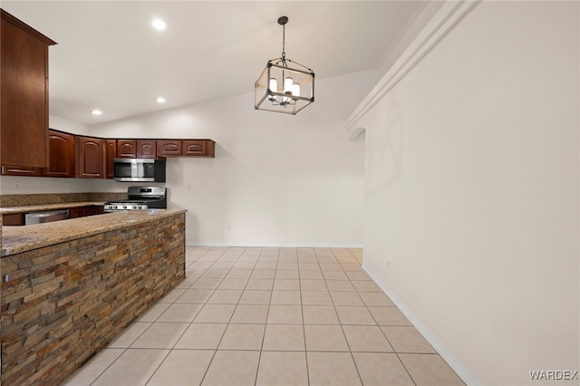 kitchen with appliances with stainless steel finishes, hanging light fixtures, light stone countertops, an inviting chandelier, and vaulted ceiling