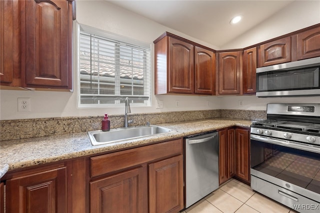 kitchen with light tile patterned floors, stainless steel appliances, light countertops, a sink, and recessed lighting