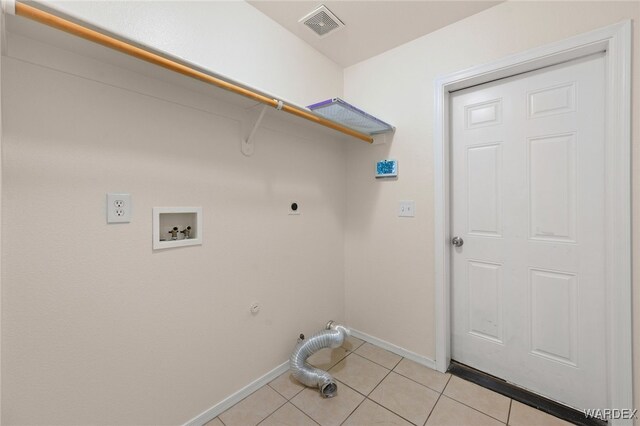 laundry area with light tile patterned flooring, hookup for a washing machine, laundry area, visible vents, and electric dryer hookup