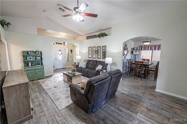 living room featuring arched walkways, visible vents, ceiling fan, and wood tiled floor