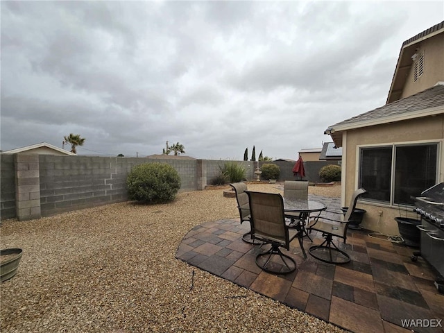 view of patio featuring a fenced backyard and outdoor dining space