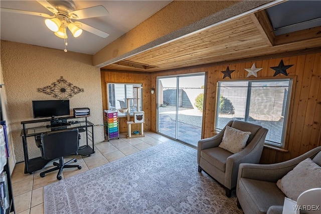 home office with light tile patterned floors, wooden ceiling, wooden walls, and ceiling fan