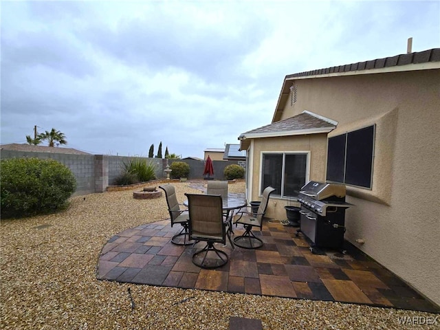 view of patio / terrace featuring outdoor dining space, a fenced backyard, and a grill