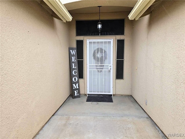 doorway to property with stucco siding