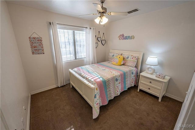 carpeted bedroom with visible vents, baseboards, and a ceiling fan
