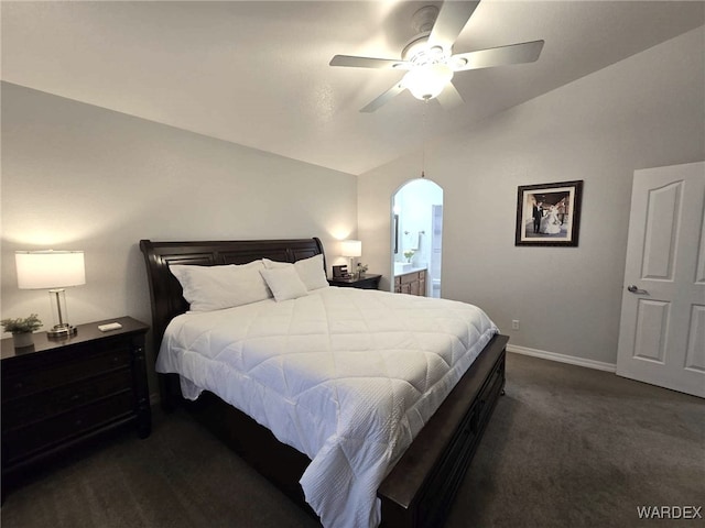 bedroom featuring ceiling fan, baseboards, dark carpet, vaulted ceiling, and arched walkways