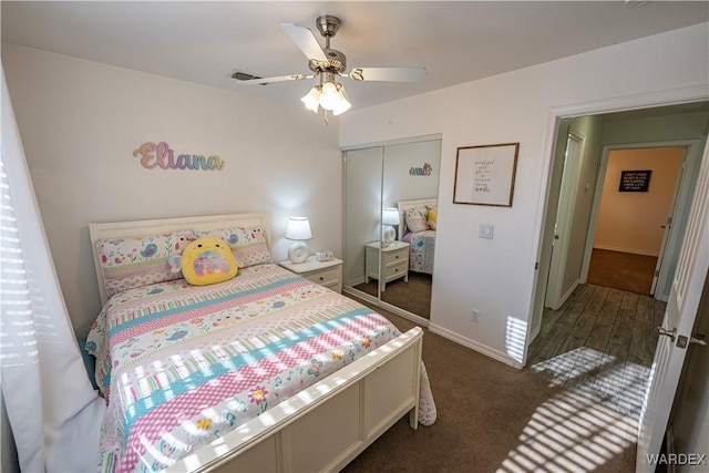 carpeted bedroom featuring a closet, baseboards, and ceiling fan