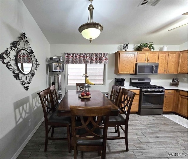 dining area featuring visible vents, baseboards, and light wood-style floors