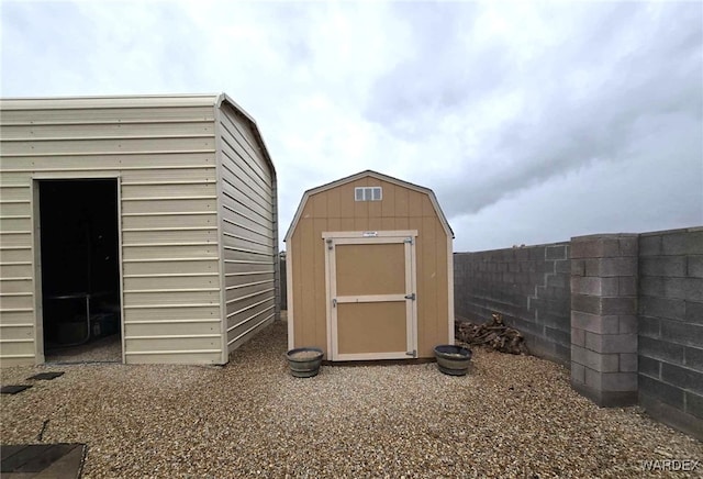 view of shed with fence