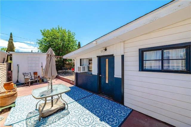 view of patio / terrace featuring an outdoor structure, cooling unit, and fence