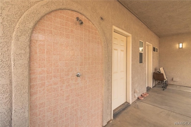 entrance to property with stucco siding