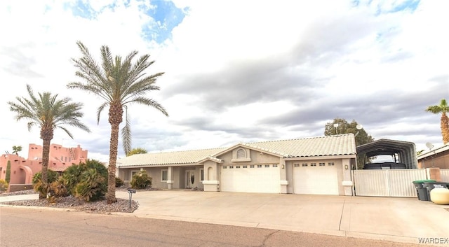 ranch-style house featuring stucco siding, driveway, a tile roof, and a garage