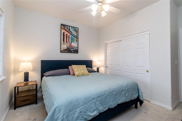 carpeted bedroom with a ceiling fan, baseboards, and a closet