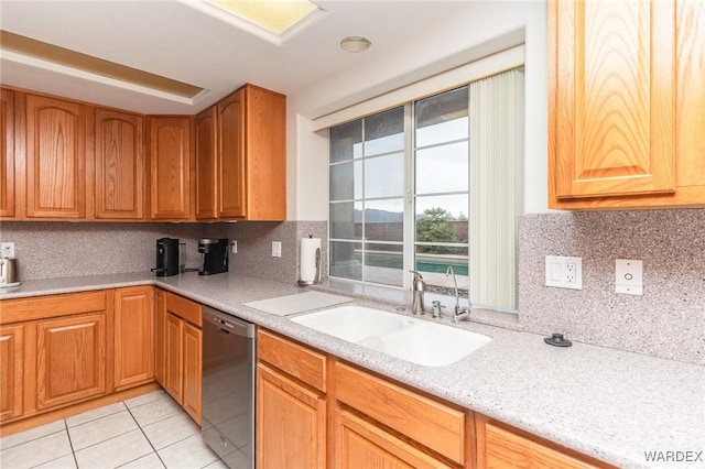 kitchen with dishwasher, light tile patterned floors, backsplash, and a sink