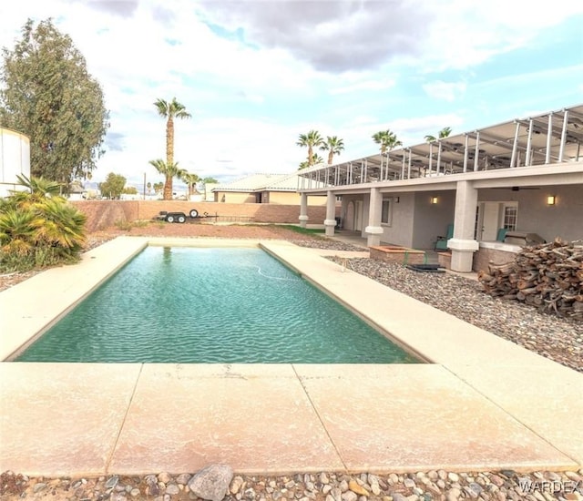 view of swimming pool featuring a patio area, a fenced in pool, and glass enclosure